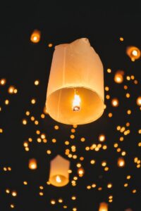 Sky lanterns glowing in the night sky