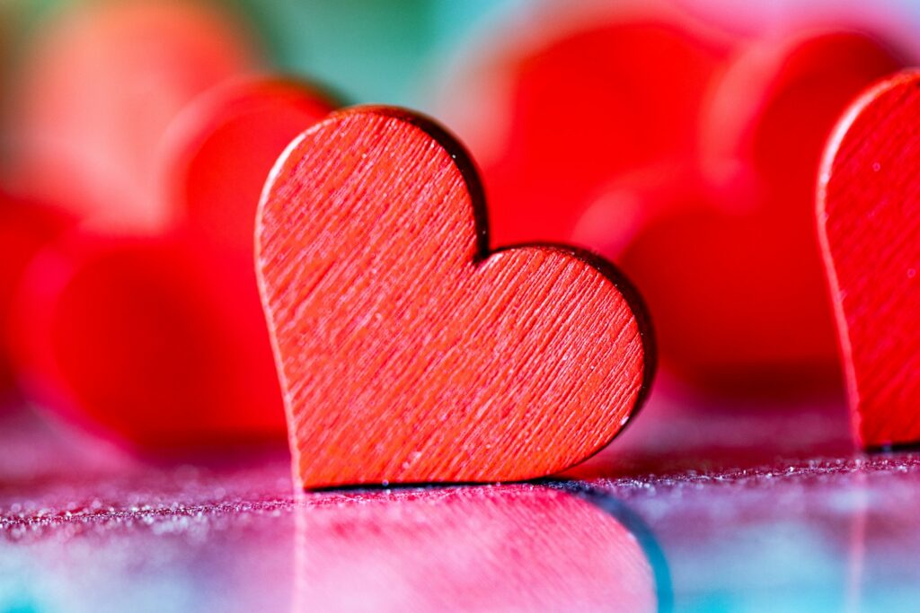 two red hearts sitting on top of a table