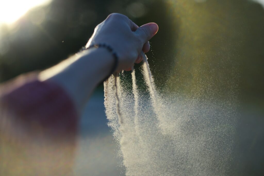A person holding their hand out to spray water