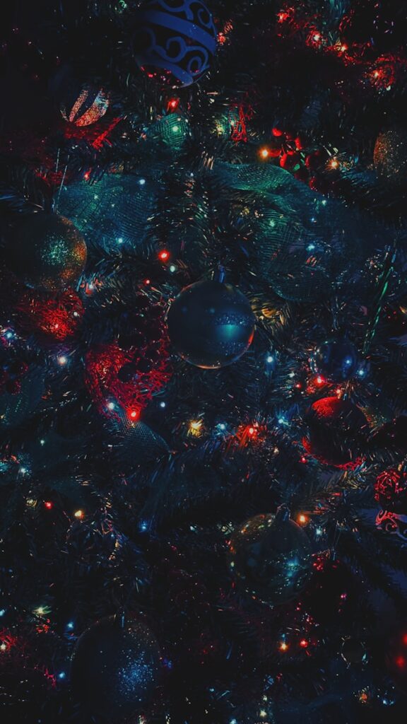 A very colorful christmas tree with ornaments on it