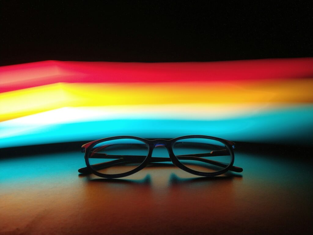 black framed eyeglasses on blue surface